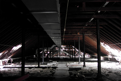The attic space of the C buildings went largely unused. A small plank walkway offers the only safe footing as the ventilation ducts hang above. 